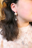 Aphrodite earrings modelled by Clara. Made by Jesse Ball at Jupiter's Grace