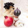 shell earrings displayed with fig, grapes, amphora and pomegranate. Made by Jesse Ball at Jupiter's Grace