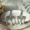 Astrum earrings displayed on a stone. Silver with pearls, made by Jesse Ball at Jupiter's Grace